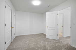 Unfurnished bedroom with light carpet