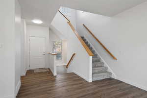 Foyer entrance featuring dark hardwood / wood-style flooring