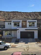 View of front facade featuring a mountain view and a garage