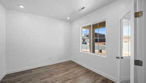 Empty room with dark wood-type flooring