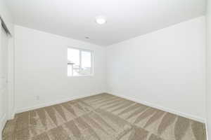 Spare room featuring carpet flooring