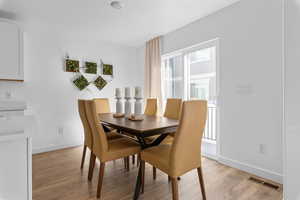 Dining area with light hardwood / wood-style floors