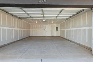 Garage featuring electric panel and a garage door opener