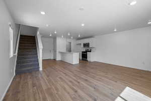 Unfurnished living room with light wood-type flooring and sink