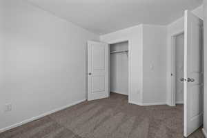 Unfurnished bedroom with carpet floors and a closet