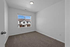 Unfurnished room featuring carpet flooring