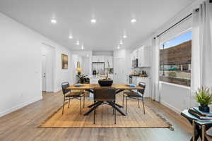 Dining area with light hardwood / wood-style floors