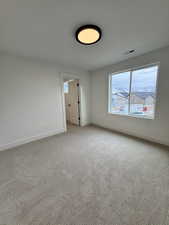 Bedroom with large walk-in closet featuring a window