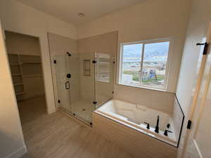 Primary Bathroom with a mountain view and separate shower and tub