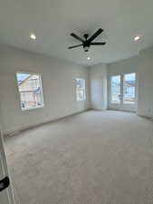 Primary Bedroom Carpeted spare room featuring a wealth of natural light and ceiling fan