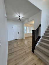 Entryway featuring light hardwood / wood-style floors and a textured ceiling