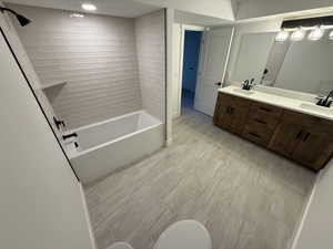 Bathroom with vanity and tiled shower / bath