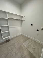 Primary closet featuring Laundry area featuring carpet, washer hookup, and hookup for an electric dryer