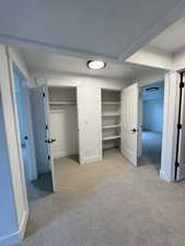 Unfurnished bedroom featuring light colored carpet