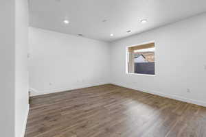 Empty room with dark hardwood / wood-style floors