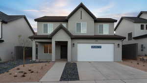 View of front of home with a porch and a garage