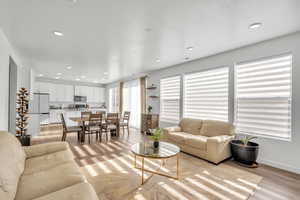 Living room featuring a textured ceiling and light hardwood / wood-style flooring