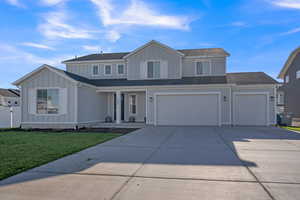 Front of property with a front yard and a garage