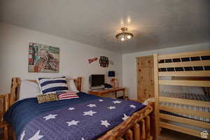 Bedroom featuring a textured ceiling and carpet floors