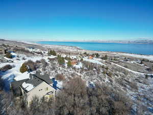 Snowy aerial view with a water view