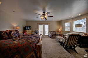 Primary bedroom with private bath light colored carpet, opens to deck facing Bear Lake