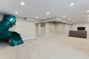 Basement featuring light carpet