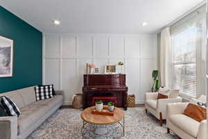 Living room featuring light hardwood / wood-style flooring and a textured ceiling