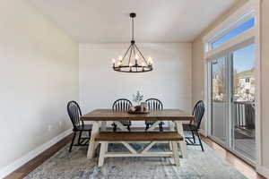 Dining room with a chandelier and hardwood / wood-style floors