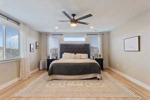 Bedroom featuring ceiling fan and light hardwood / wood-style floors