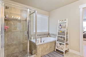 Bathroom featuring tile patterned flooring and independent shower and bath