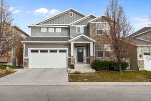 Craftsman-style home featuring a garage and a front lawn