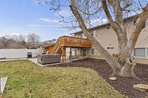 Back of house featuring a patio, a deck, and a lawn