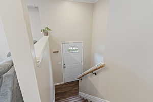 Staircase featuring hardwood / wood-style flooring