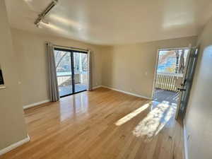 Interior space featuring track lighting and light hardwood / wood-style flooring