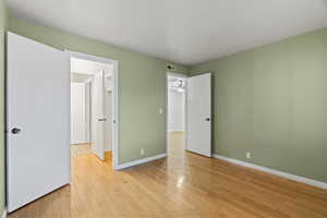 Unfurnished bedroom featuring light wood-type flooring