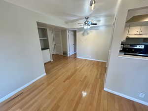 Interior space with ceiling fan and light hardwood / wood-style flooring