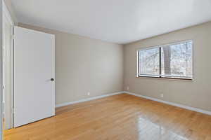 Empty room with light hardwood / wood-style flooring