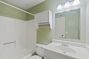 Full bathroom featuring vanity, toilet, and bathing tub / shower combination