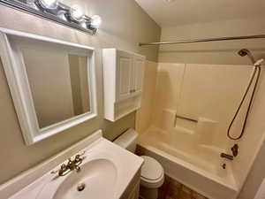 Full bathroom featuring  shower combination, toilet, and sink