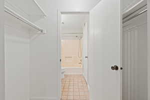 Spacious closet with light tile patterned flooring