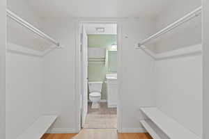 Walk in closet featuring light hardwood / wood-style flooring