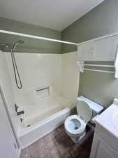 Full bathroom featuring toilet, vanity, and washtub / shower combination