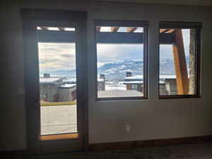 Entryway to master bedroom and hot tub featuring a wealth of natural light and a mountain view