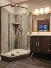 Main level Bathroom with tile patterned flooring and walk in shower, toilet