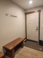 View of mudroom, door to garage and extra coat rack