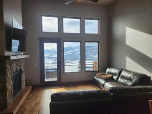 Living room featuring a fireplace, amazing exterior views,, hardwood flooring, and a healthy amount of sunlight