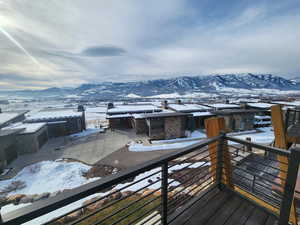 Snow covered deck with a mountain view