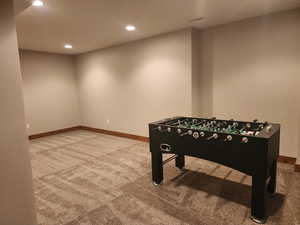 Recreation room/Theater Room with carpet and Foosball table