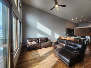 Living room with hardwood / wood flooring and ceiling fan