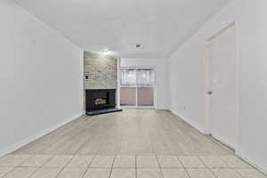 Unfurnished living room featuring a fireplace and light hardwood / wood-style flooring